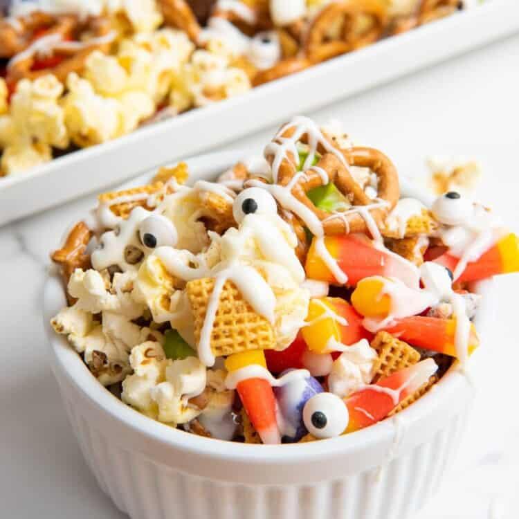 Halloween chex mix served in a small white bowl
