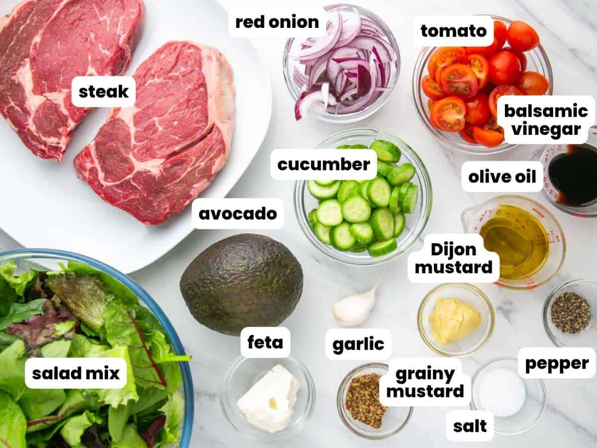 The ingredients needed to make a steak salad with fresh veggies and homemade dressing