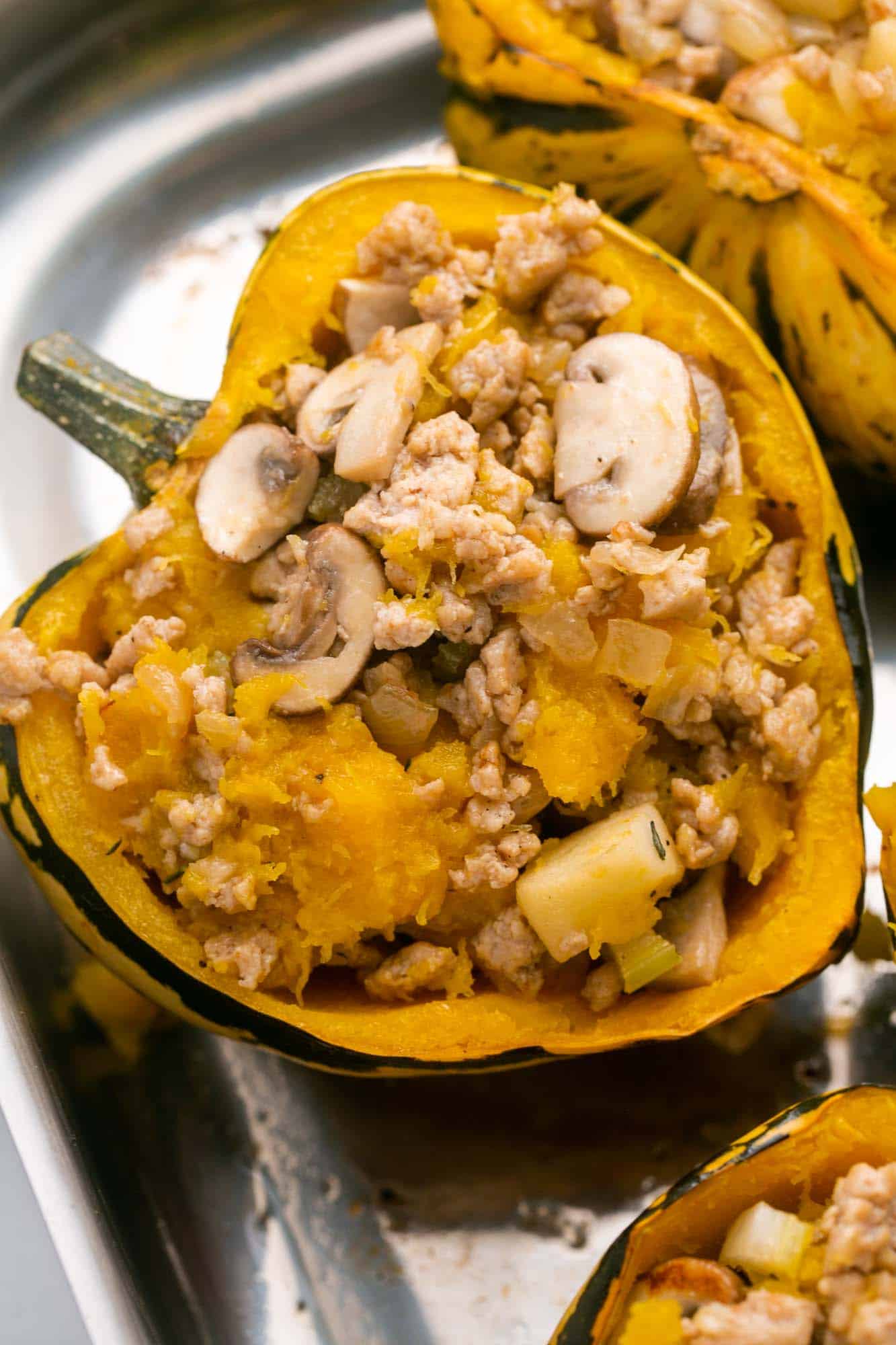 Stuffed acorn squash with ground chicken, apple, and mushrooms