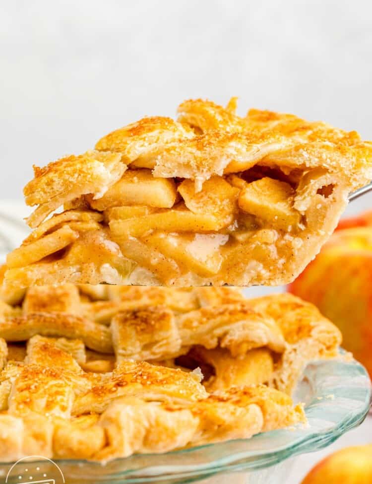 Taking a slice of apple pie out of the pie dish