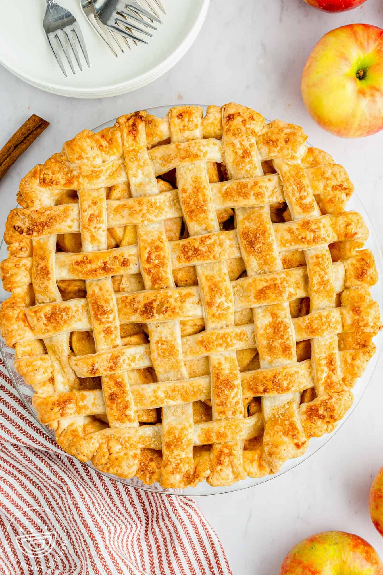 top down view of a golden brown lattice topped apple pie.