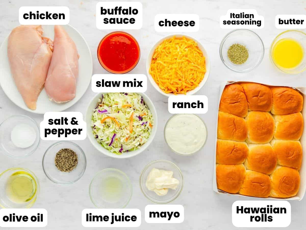 The ingredients for making buffalo chicken sliders, including chicken breasts, hawaiian rolls, slaw mix, and seasonings.