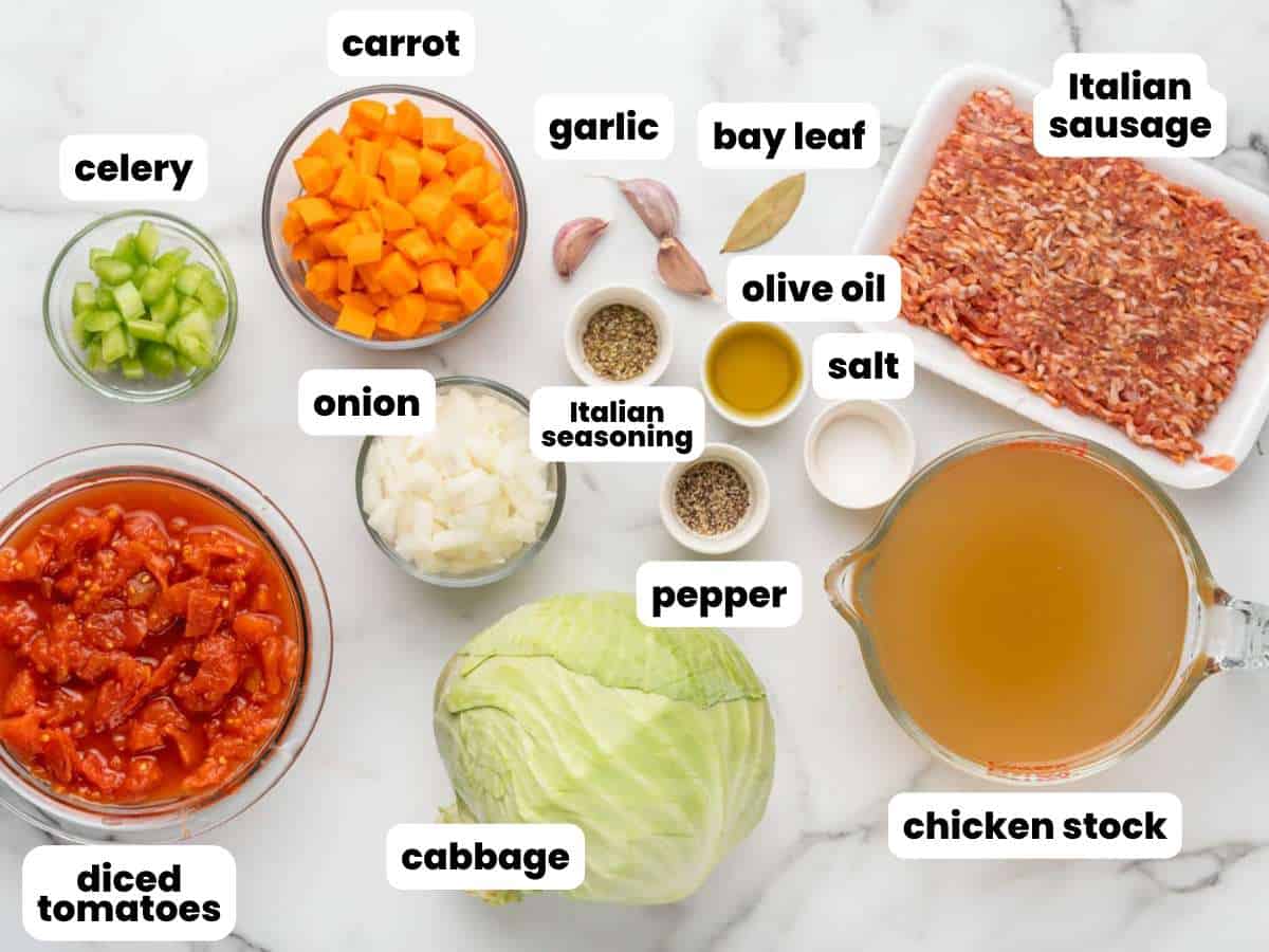 The ingredients for making soup with sausage and cabbage, all in separate bowls, on a counter. Each is labeled by a text box overlay.