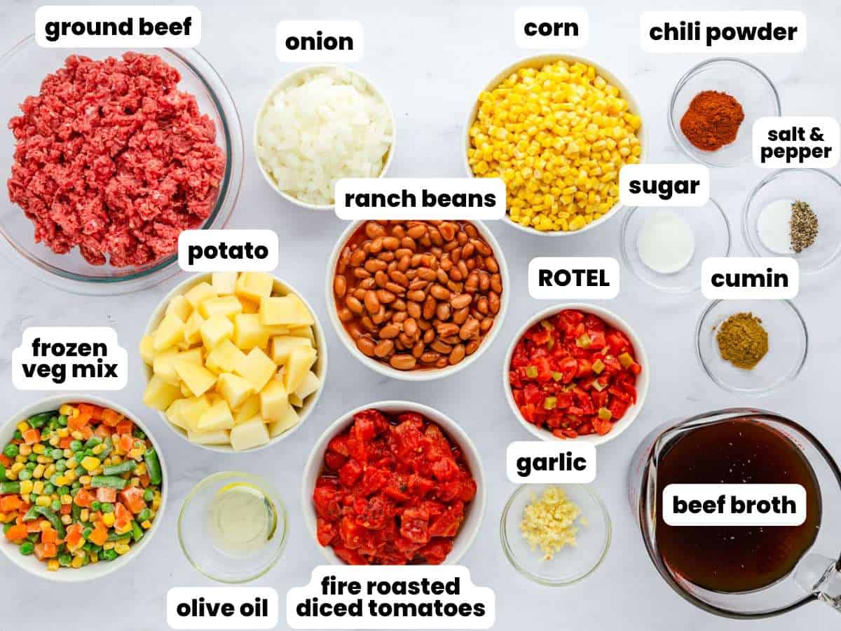 Small bowls of ingredients for cowboy soup are arranged on a counter, viewed from above. Each ingredient is labeled with a white text box.