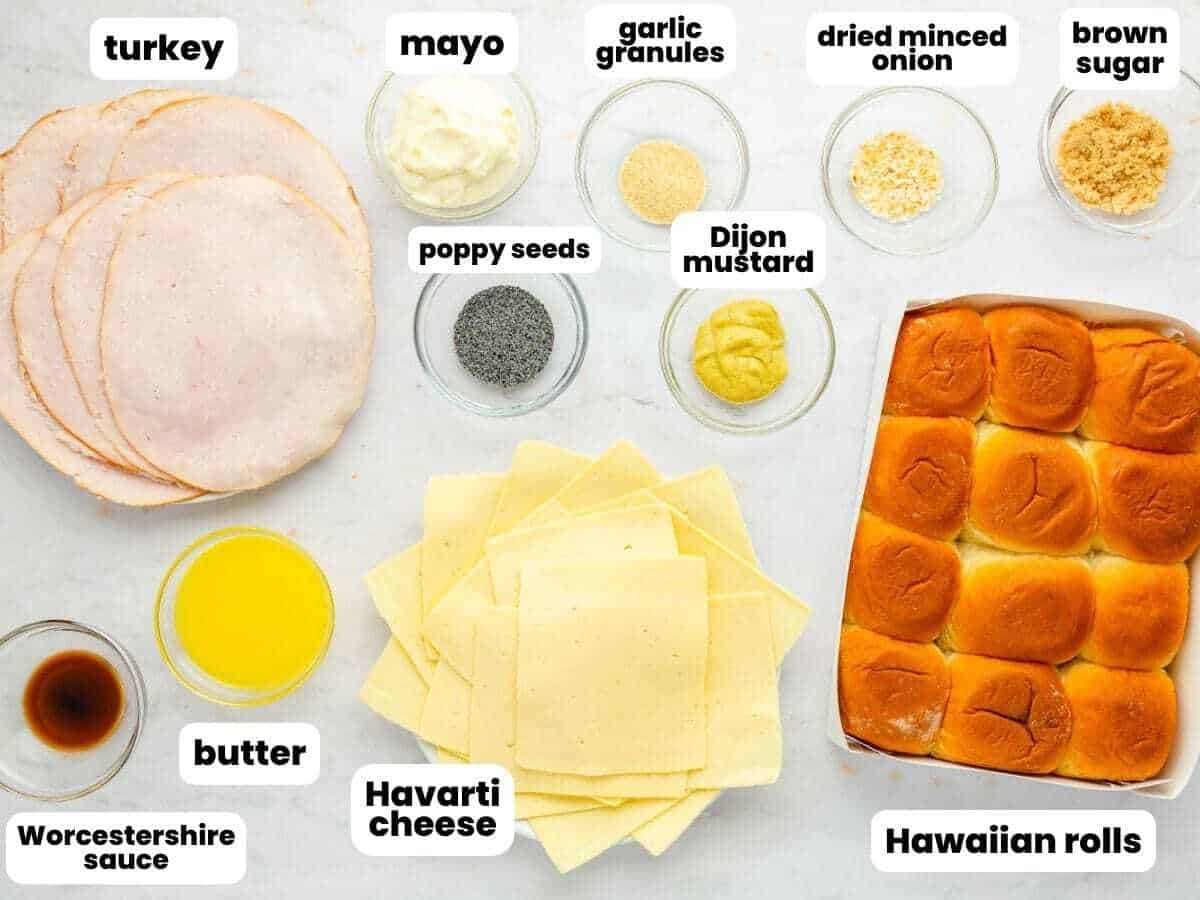 The ingredients for turkey sliders, deli turkey, havarti cheese, hawaiian rolls, butter, and seasonings