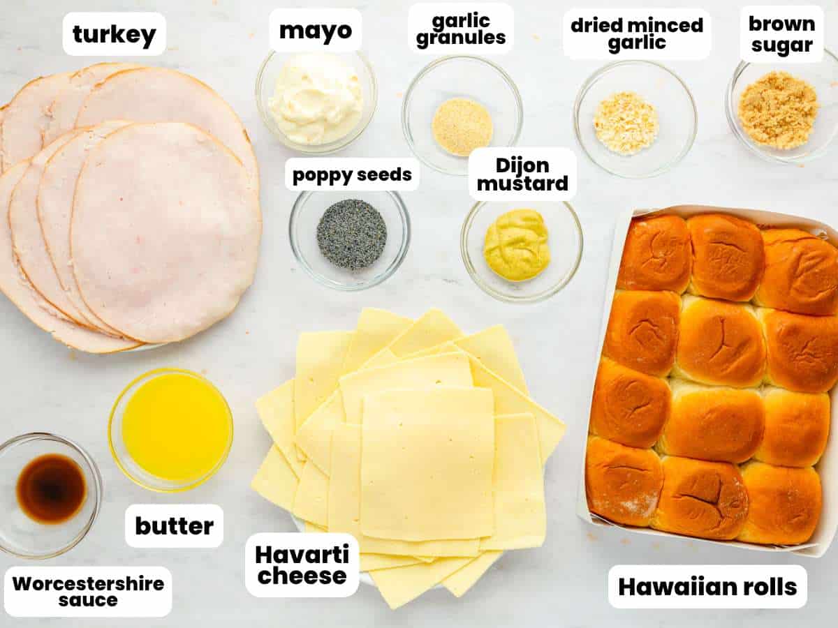 The ingredients needed to make turkey sliders, including deli turkey, havarti cheese, and hawaiian rolls. Each ingredient is measured into small bowls, arranged on the counter. Text boxes label each item.