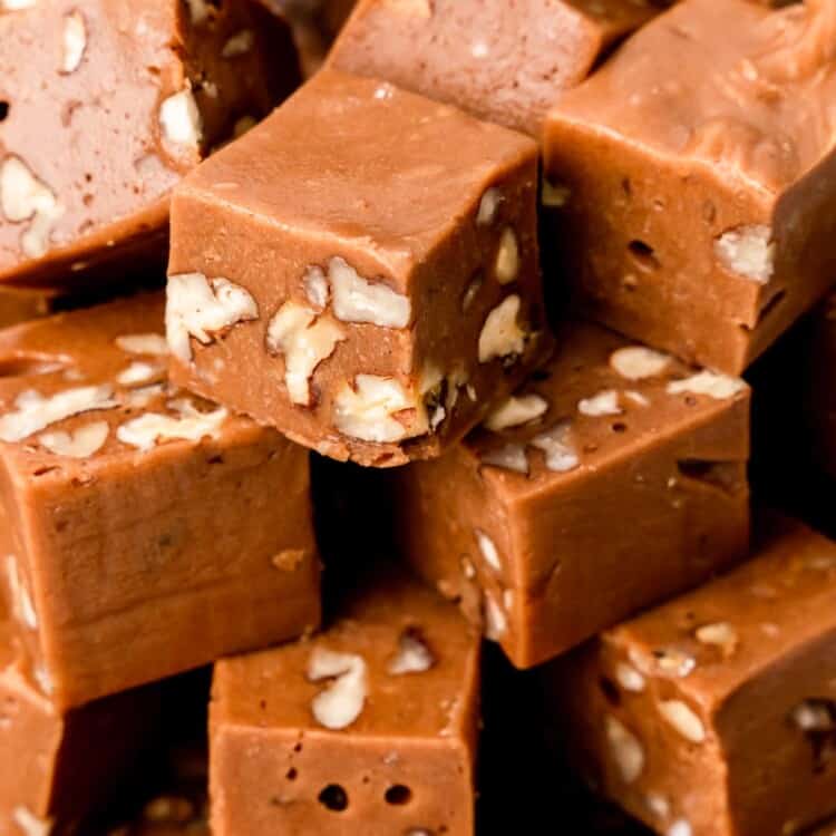 closeup of a stack of fudge squares with walnuts inside.