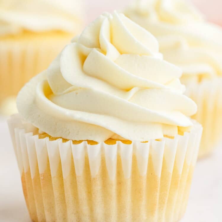 A cupcake frosted with white chocolate buttercream