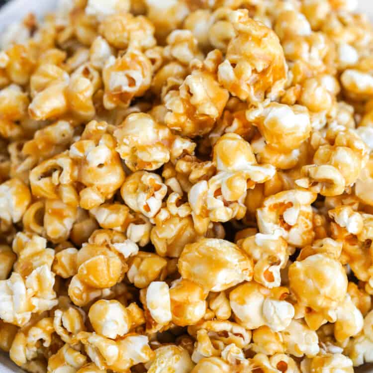 a large white bowl filled with caramel popcorn.