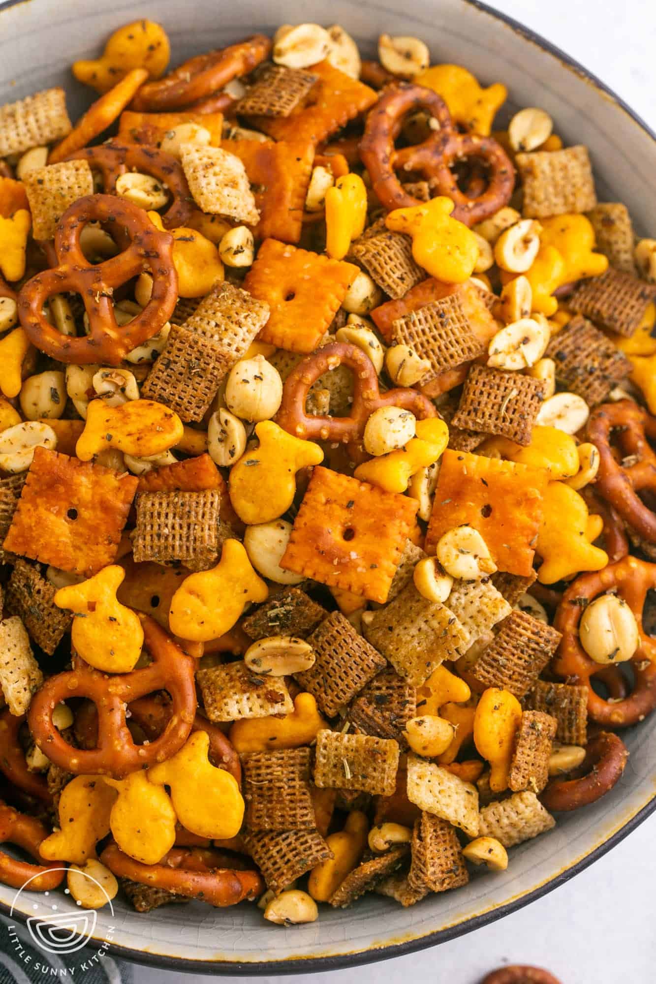 a large bowl filled with homemade chex mix with cheeze its and gold fish