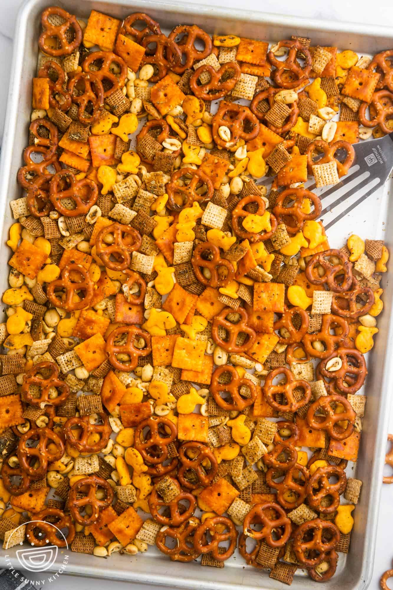 homemade chex mix on a baking sheet.