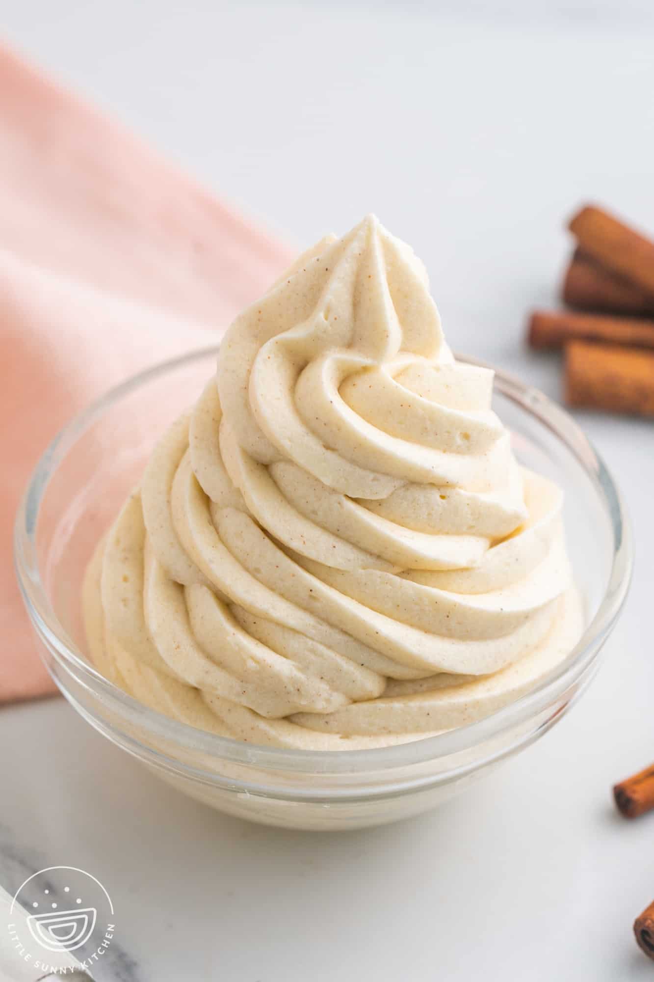 Piped cinnamon cream cheese frosting in a small bowl
