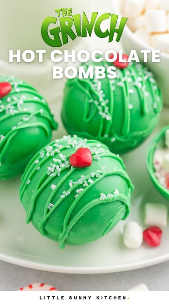Three green hot chocolate bombs with heart sprinkles on them for grinch theme, with overlay text that says "the grinch hot chocolate bombs"