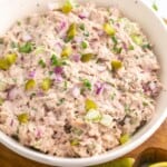 a white bowl filled with homemade tuna salad with pickles.