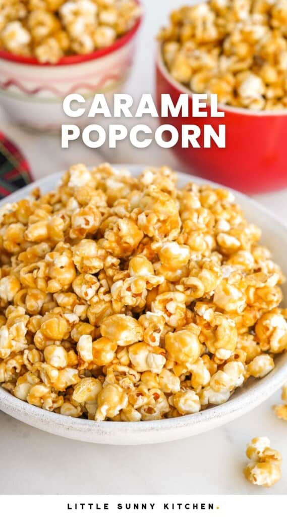a large bowl of caramel popcorn with smaller bowls behind it.