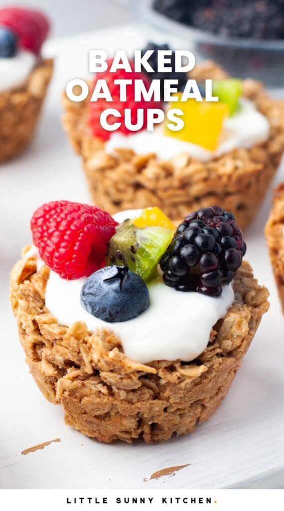 small oatmeal bowls filled with yogurt and fresh berries. Text overlay says "baked oatmeal cups"