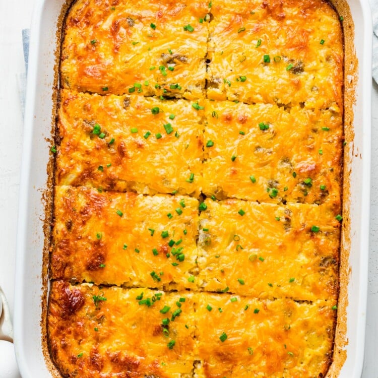 a white rectangular dish filled with bisquick breakfast casserole that has been sliced into 8 pieces.