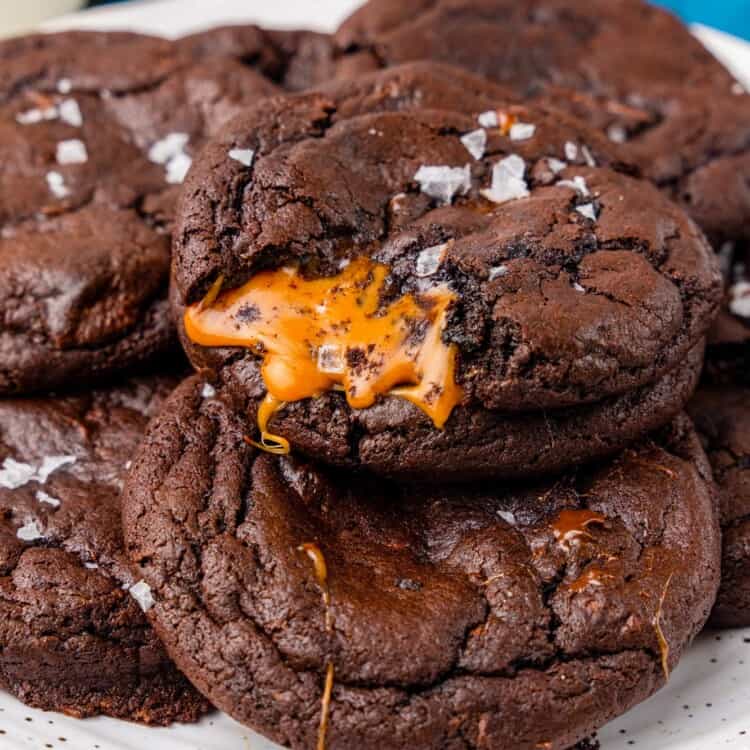 A plate of chocolate cookies with caramel inside.