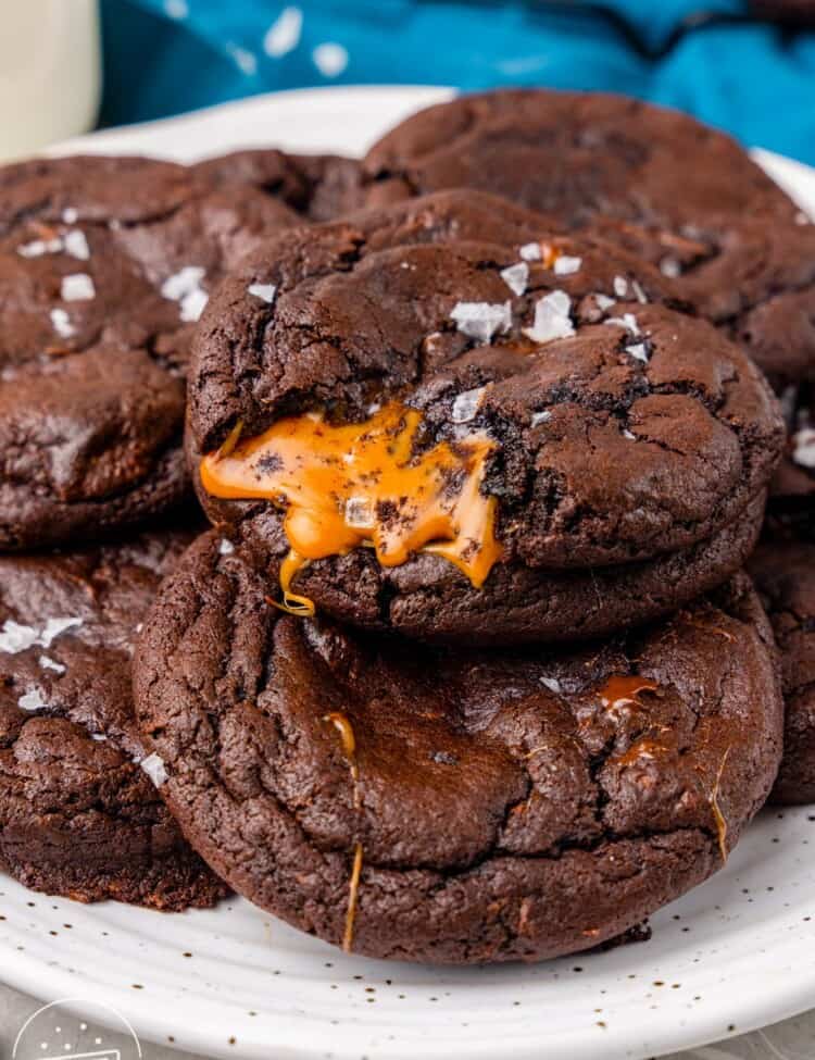 A plate of chocolate cookies with caramel inside.