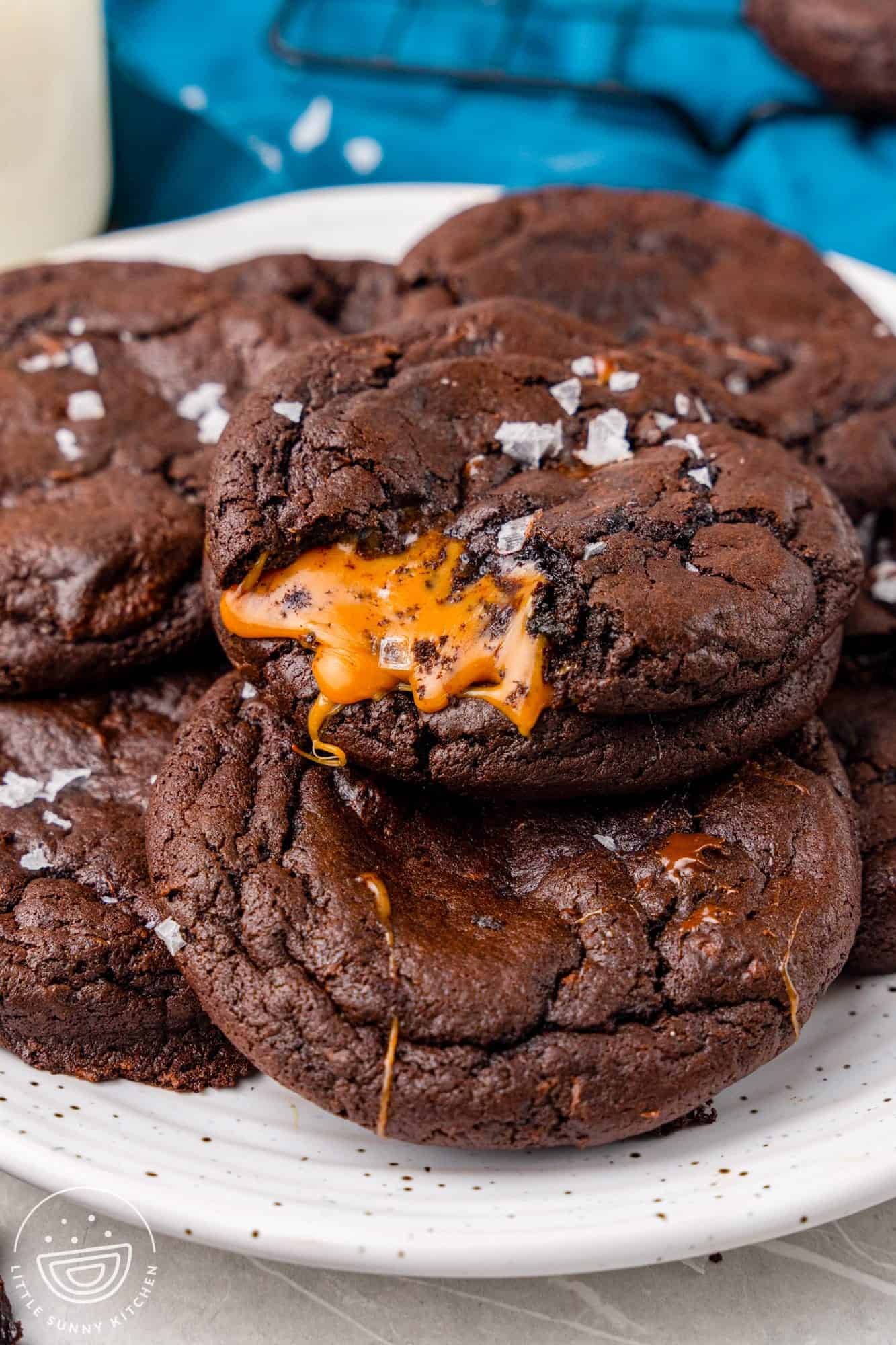 A plate of chocolate cookies with caramel inside. 