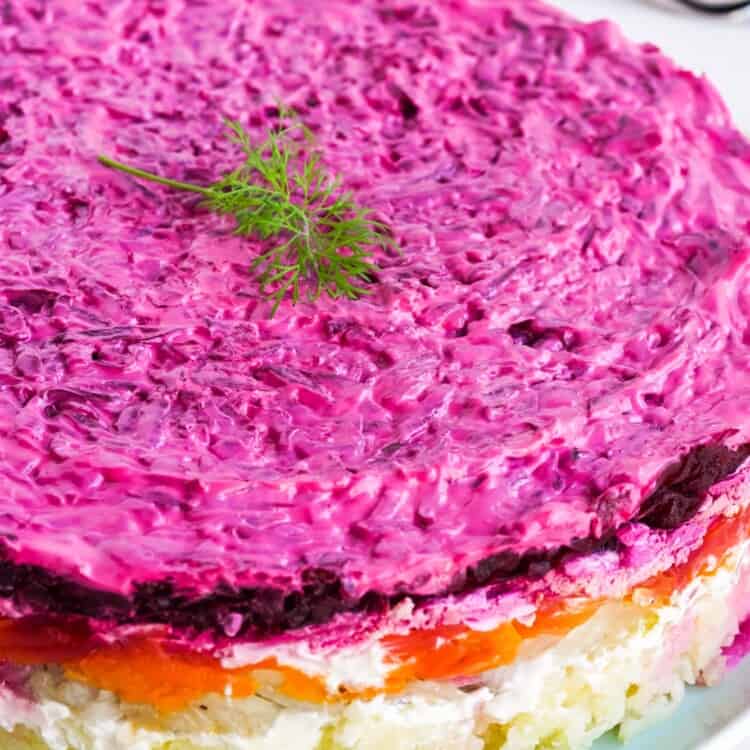 Herring under a fur coat layered salad on a large plate