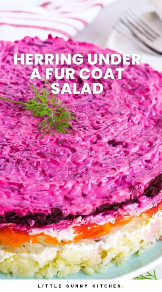 Herring Under a Fur Coat Salad showing the layers with fresh dill on top. And overlay text that says "Herring Under a Fur Coat Salad"