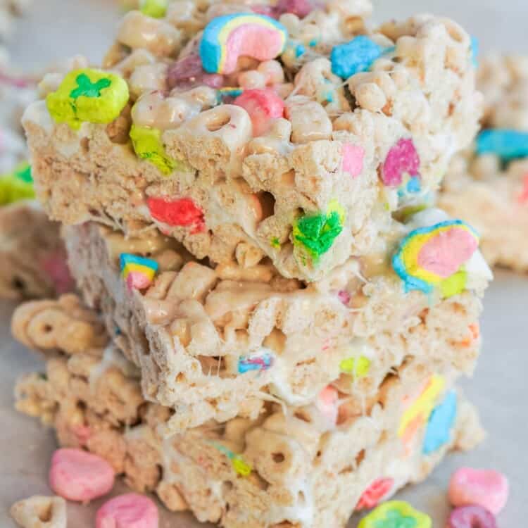 3 stacked lucky charms treats on a metal tray lined with parchment paper
