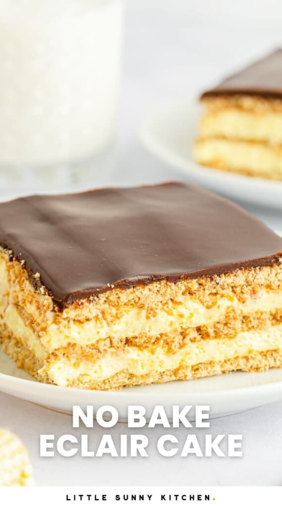 No Bake Eclair Cake slice served on a small white plate, with a glass of milk in the background, and overlay text that says "no bake eclair cake"