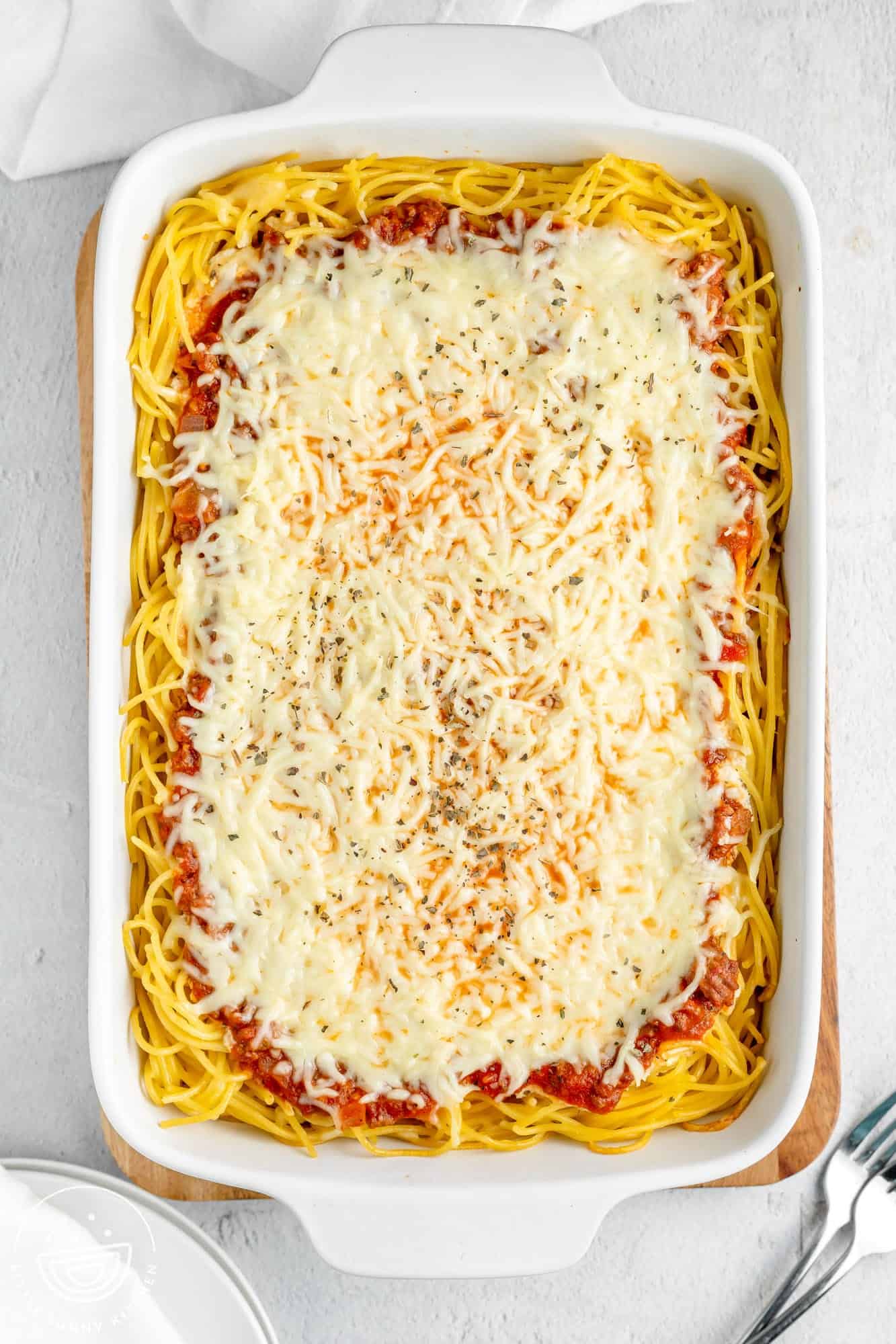 overhead view of baked spaghetti pie filled with cheese.