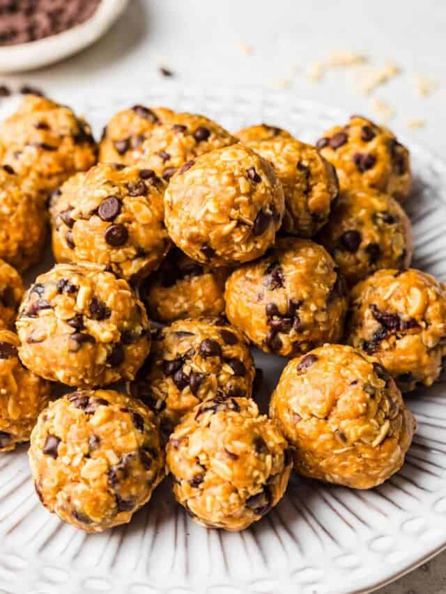 a ridged white plate stacked with chocolate chip oatmeal balls.