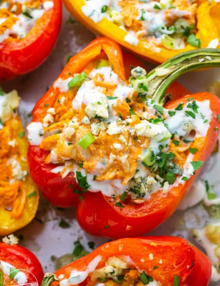 A red pepper filled with buffalo chicken, baked and topped with blue cheese and herbs.
