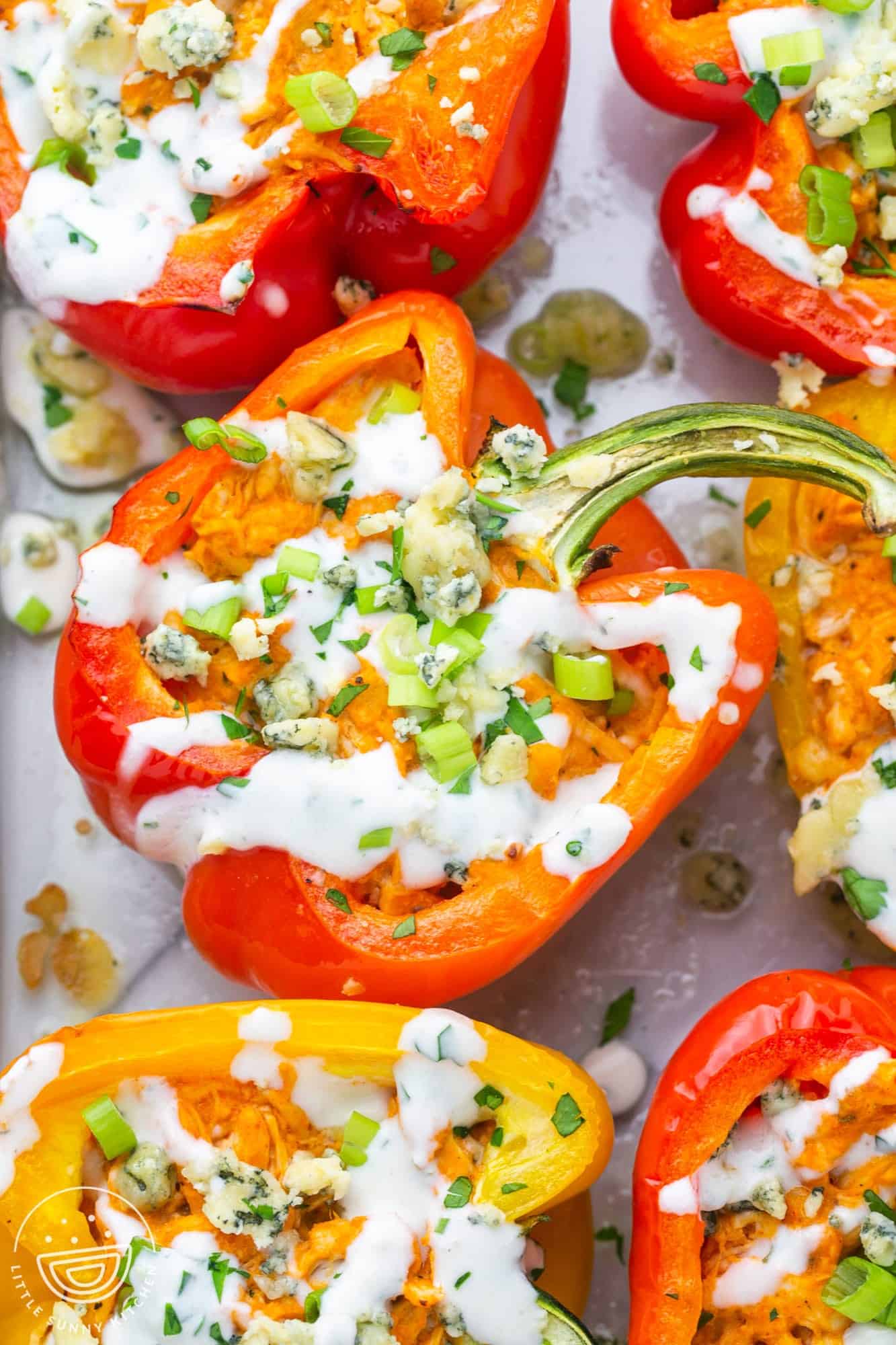 Red and yellow bell peppers, cut in half and baked, stuffed with buffalo chicken and blue cheese.