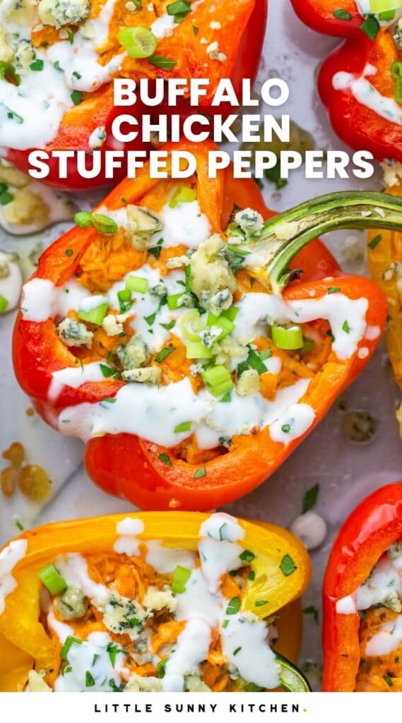 Stuffed peppers with buffalo chicken, topped with blue cheese and chopped herbs. Text overlay says "buffalo chicken stuffed peppers"