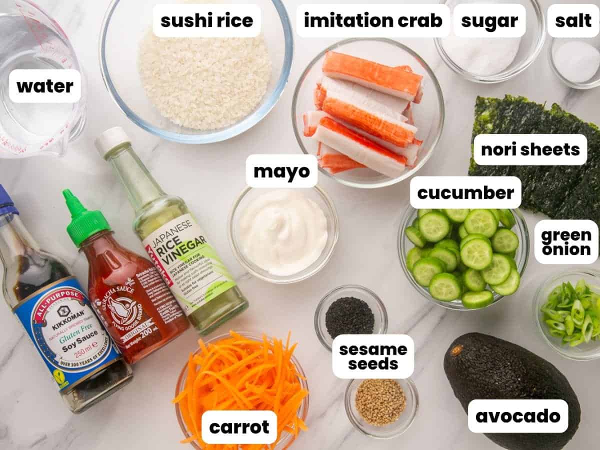 The ingredients needed to make a california roll sushi bowl, laid out on a counter and labeled.