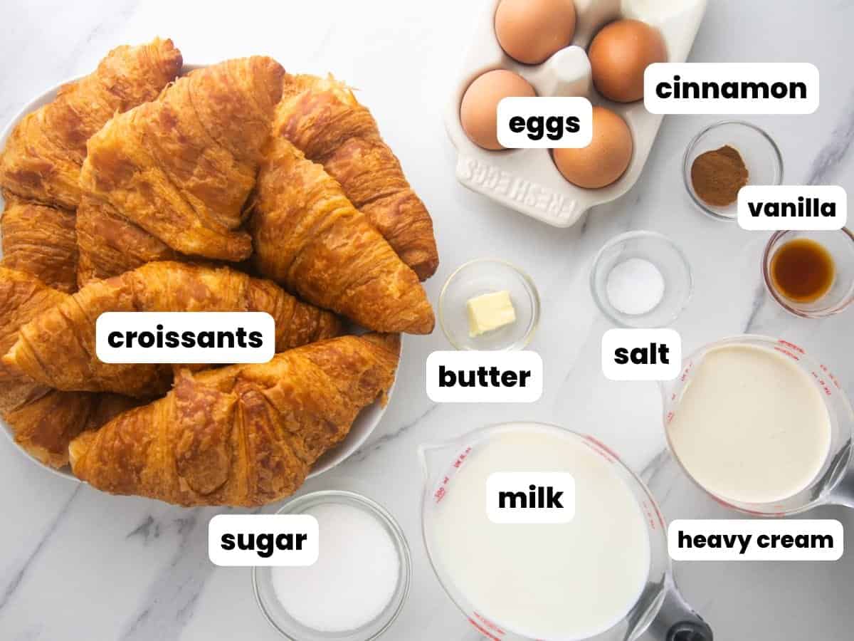 a plate of croissants with all of the other ingredients needed to make sweet bread pudding.