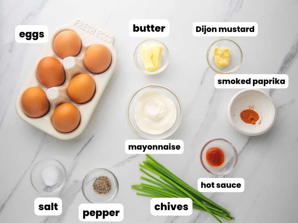 The ingredients needed to make deviled eggs, all in small bowls.