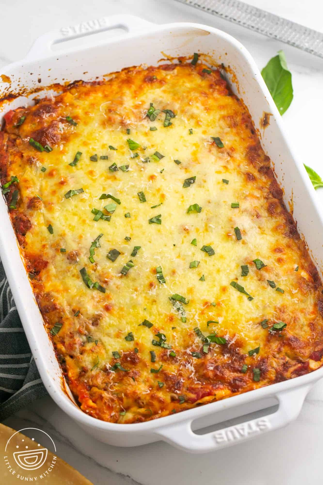 a large white baking dish filled with lasagna