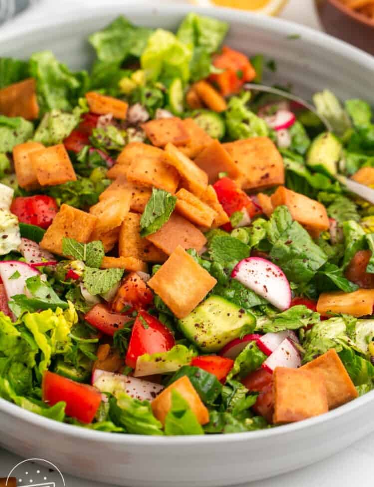 a large white bowl filled with fattoush salad.