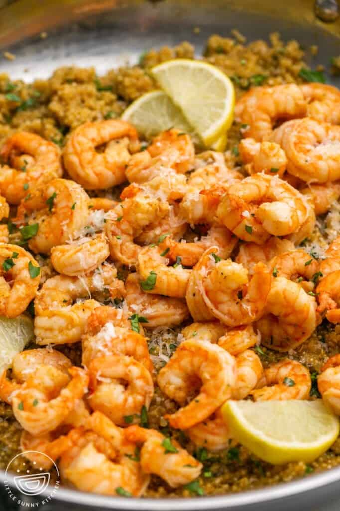 a skillet of pan seared shrimp over quinoa