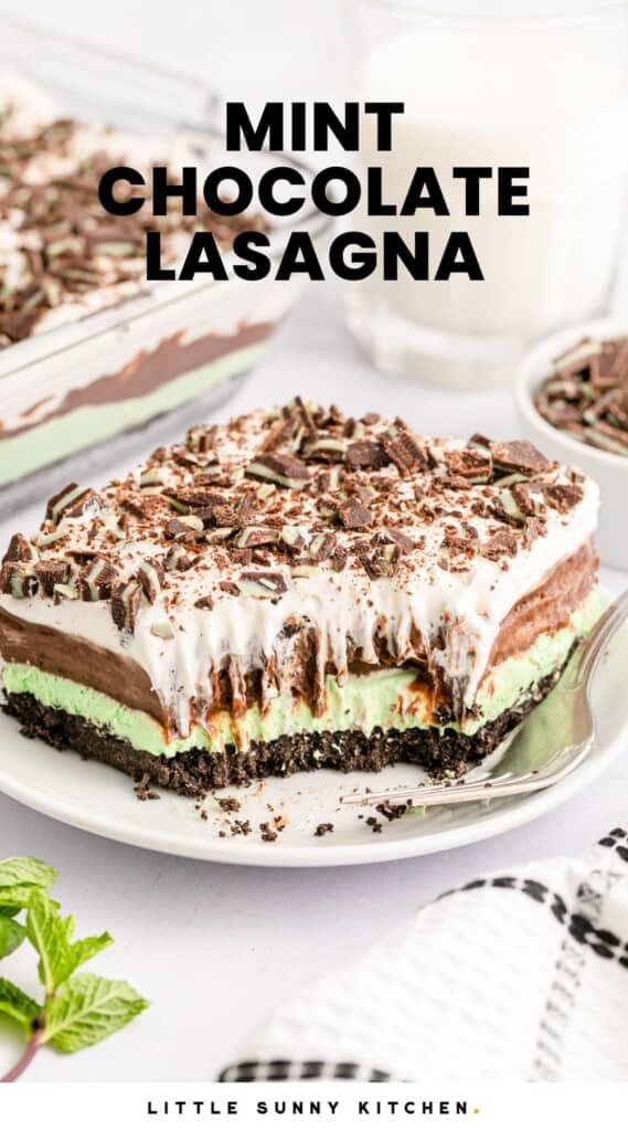 a large slice of mint chocolate lasagna with a bite taken from the front corner. there is a fork on the right side of the plate. Text overlay says "mint chocolate lasagna"