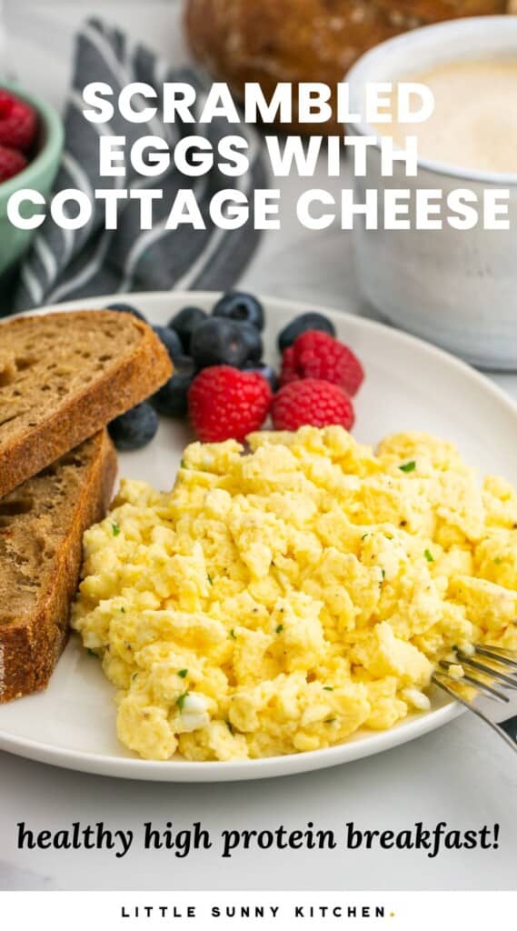 a plate of eggs with cottage cheese with two slices of toast and fresh berries. Text overlay says Scrambled Eggs with Cottage Cheese, healthy high protein breakfast