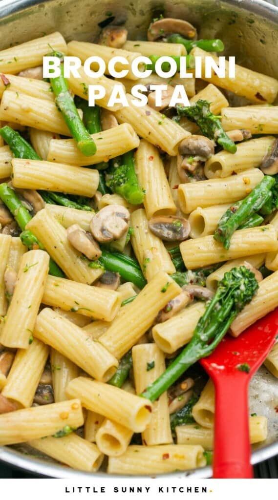 Rigatoni with mushrooms and broccolini in a skillet. Text overlay says "broccolini pasta"