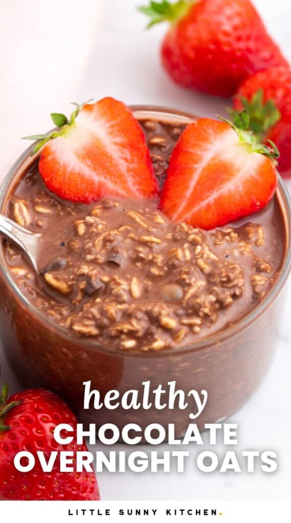 a glass jar of chocolate oatmeal with sliced strawberries on top. Text overlay says "healthy overnight oats"