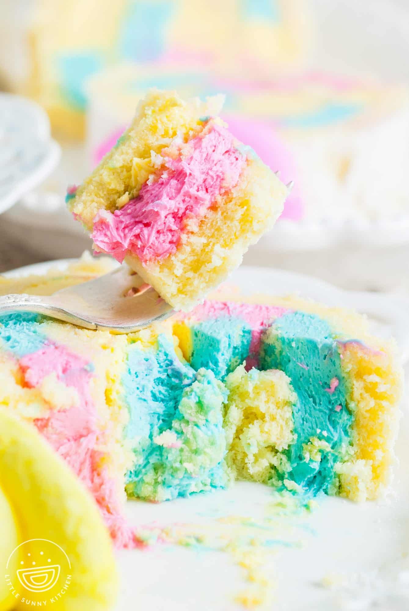 a fork holding a bite of spongy easter cake.
