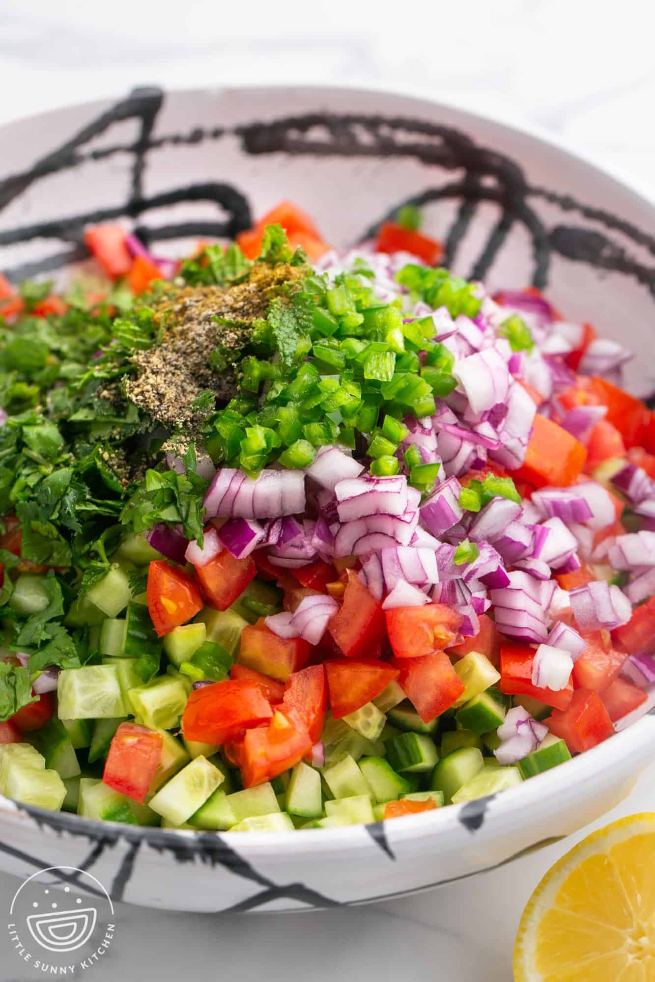 Vegetables and herbs diced small, in a large bowl before mixing the salad