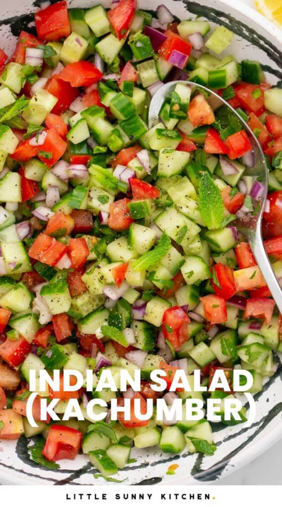 Overhead shot of an indian salad served in a white and black bowl. And overlay text that says "Indian Salad (Kachumber)"