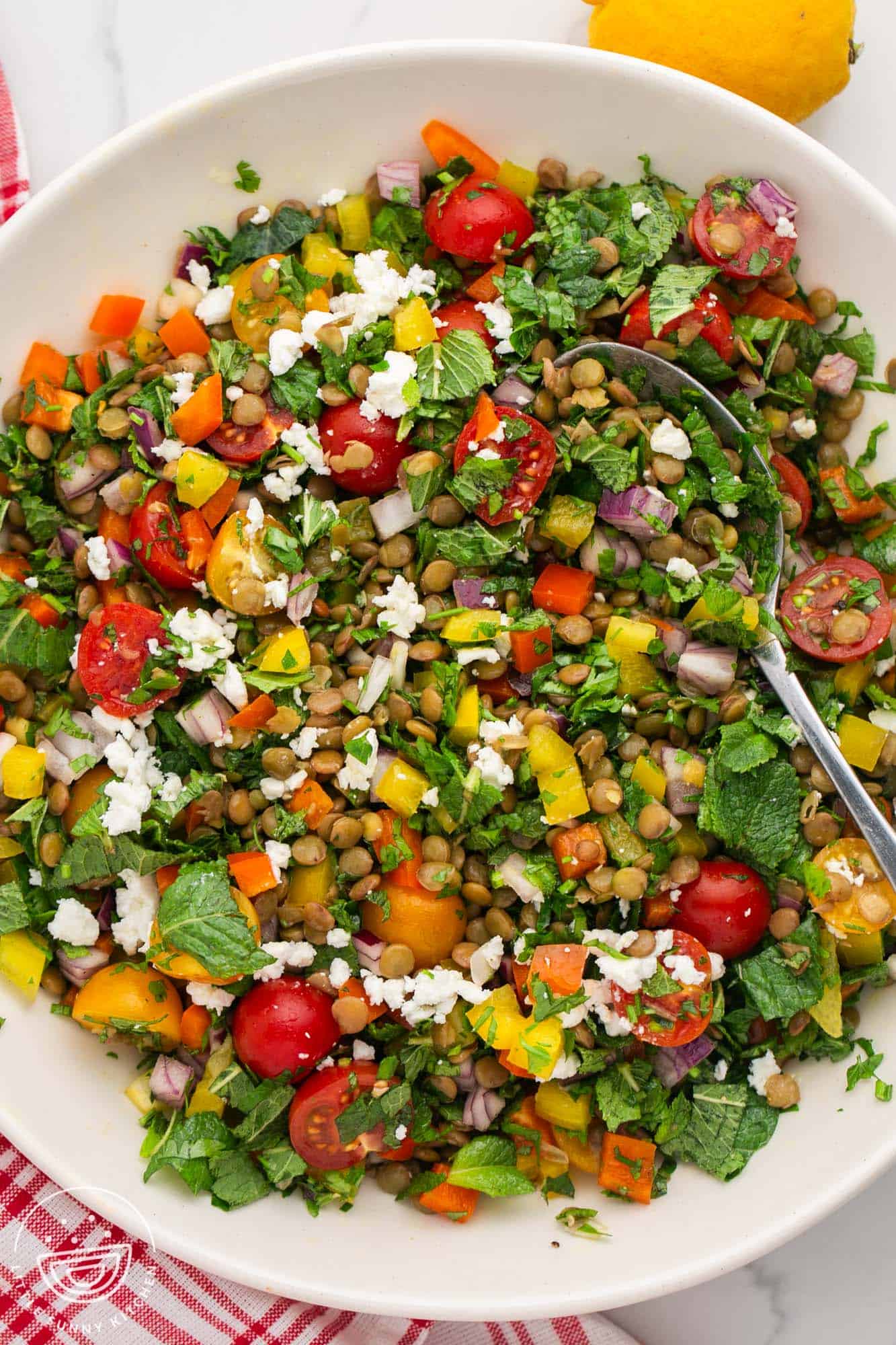 lentil salad with tomatoes, feta, herbs, in a bowl