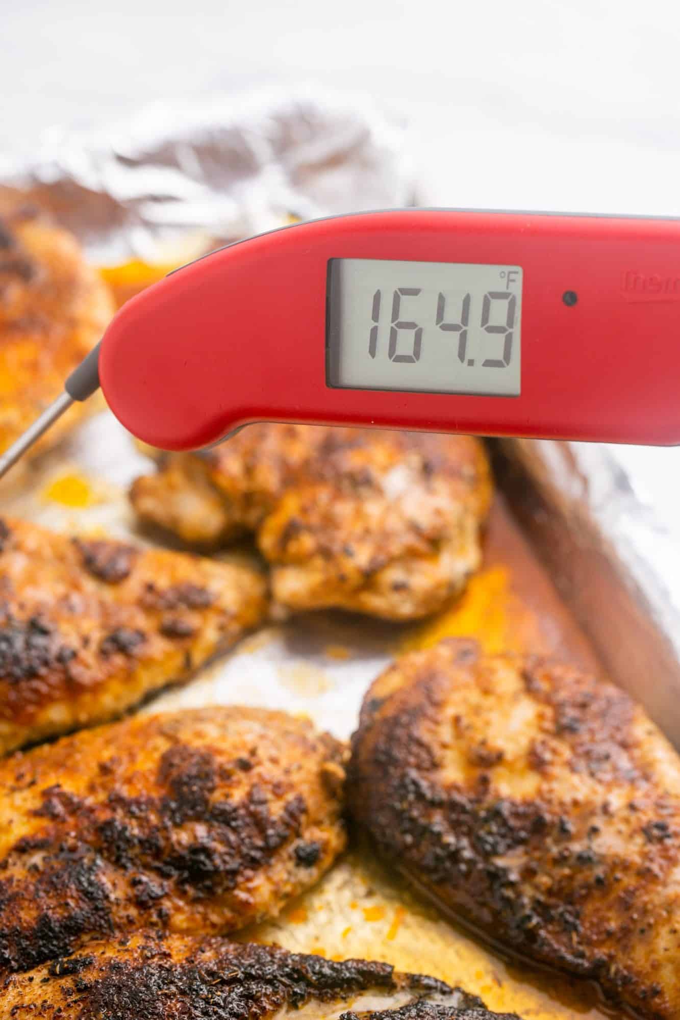 Temping blackened chicken showing the internal temperature at 165F