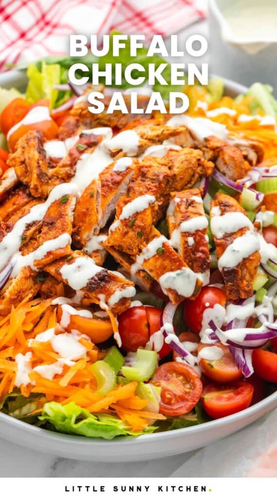 a large salad topped with spicy buffalo chicken and ranch dressing. Text overlay says "buffalo chicken salad"