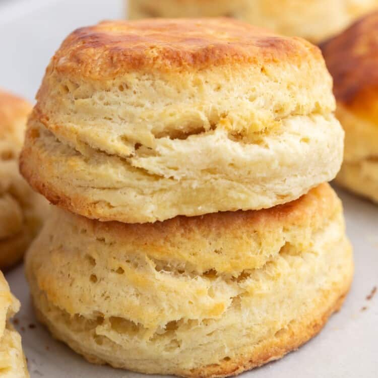 two buttermilk biscuits stacked on top of each other.